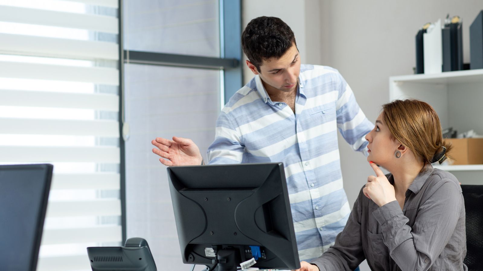 Male and female employees discussing in the office