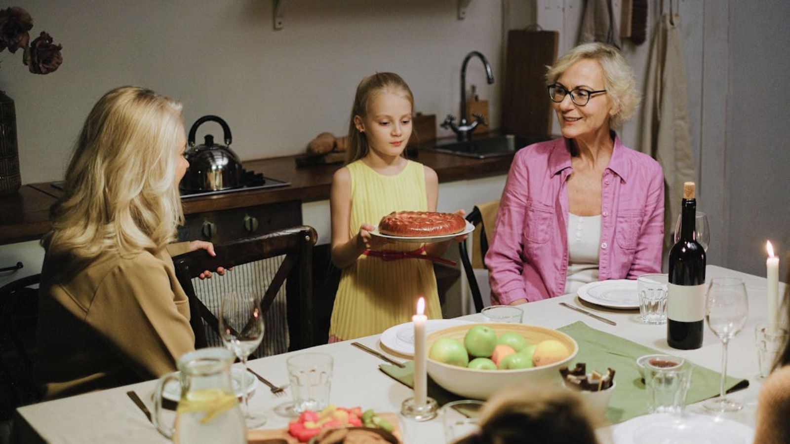 Family having dinner with food and candles