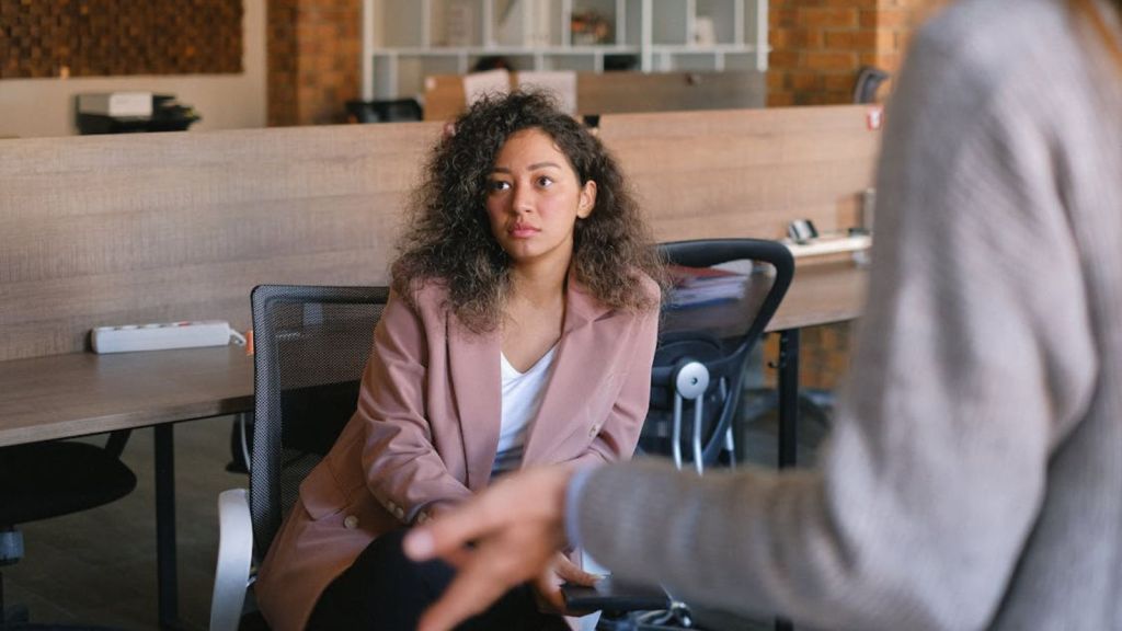 Employee talking to a colleague with a poker face