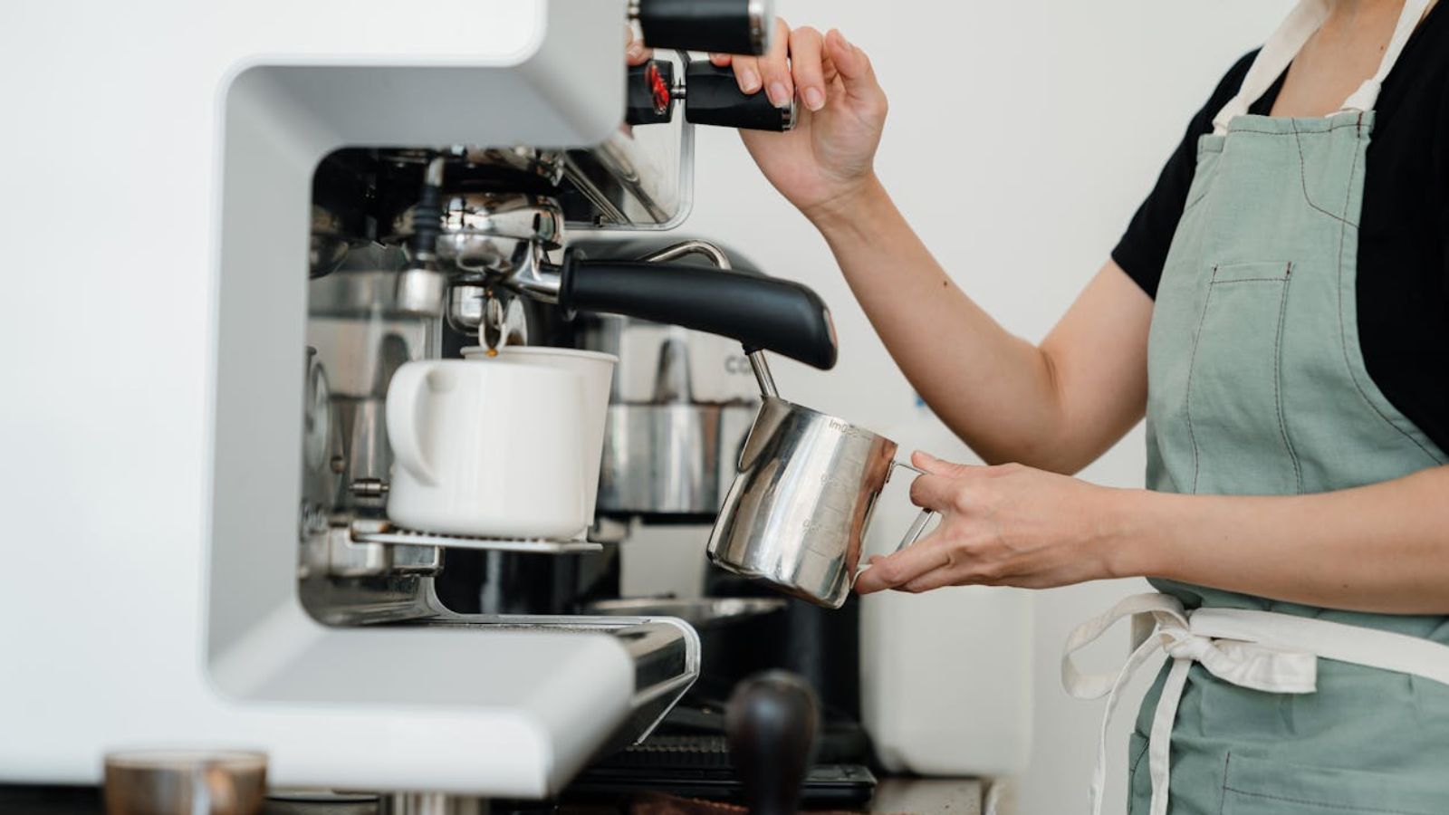 Woman preparing coffee using a machine