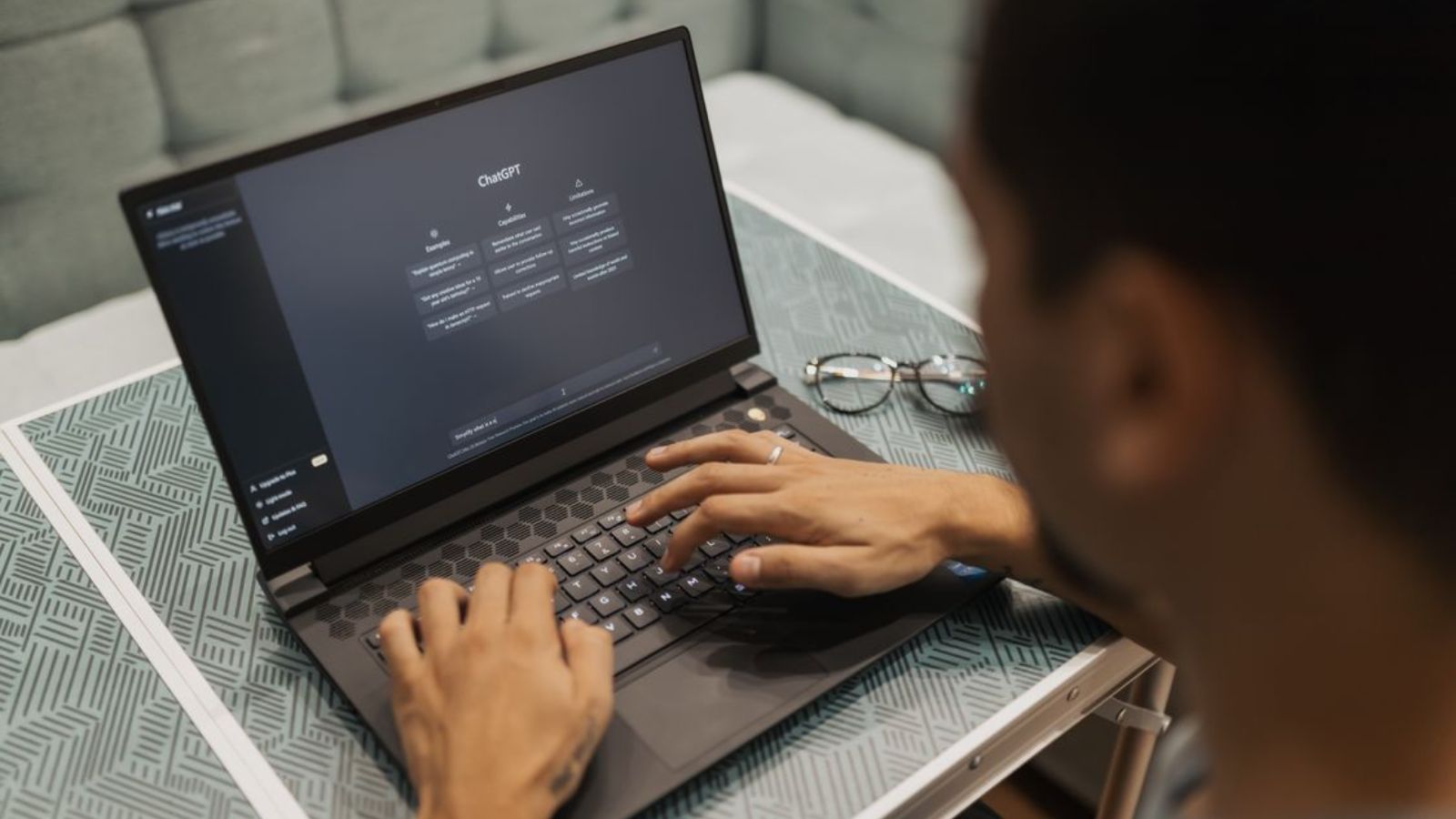 Man Learned That His Friend’s Company Replaced Their Entire Content Team With AI Tools, So He Was Shocked By The Quality Of The Results Man using ChatGPT on his laptop
