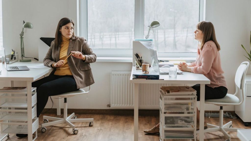 Two employees on their desk in an office