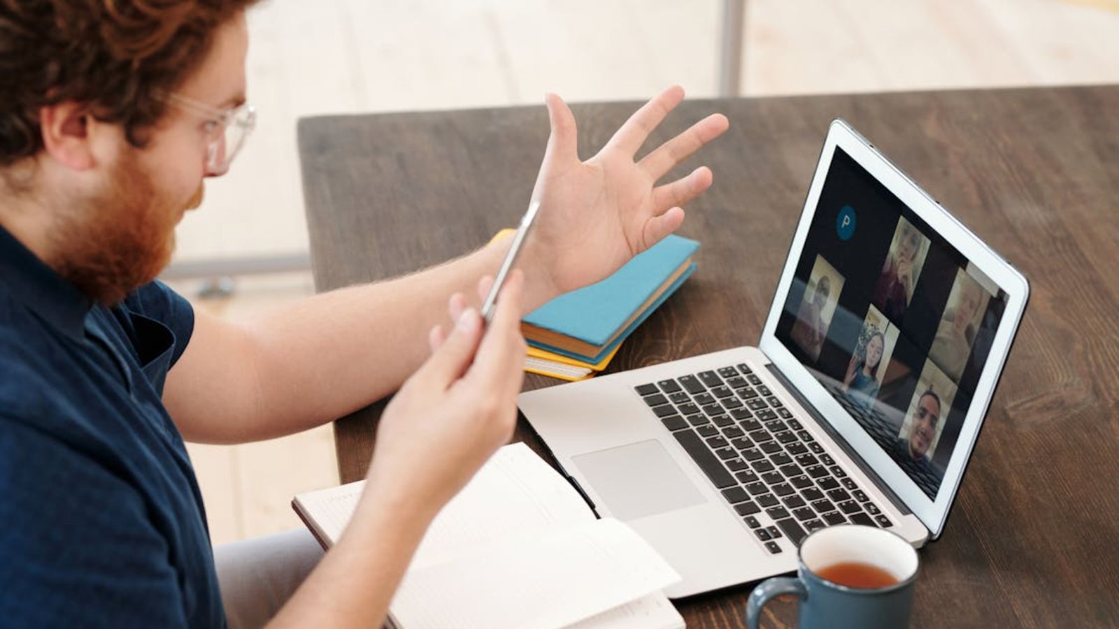 Man Keeps Getting Interrupted During Zoom Meetings and Eventually Stops Speaking Up Man having an online meeting with colleagues using his laptop