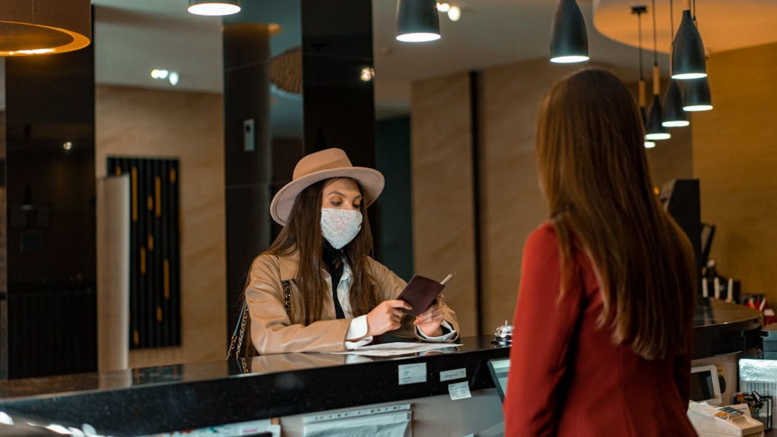 Employee Stays Professional as Guest Argues Over Small Price Differences and Discounts Woman checking in at the hotel reception