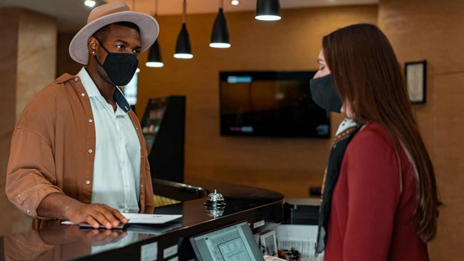 A Hospitality Job Filled With Difficult Guests Makes One Woman Reconsider Her Future Career Path Man talking to the female front desk officer in a hotel