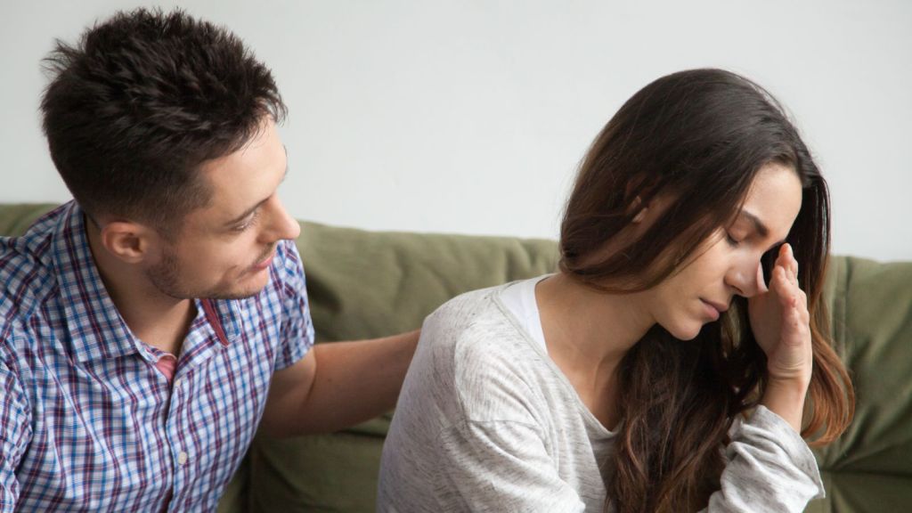 Man comforting an upset woman