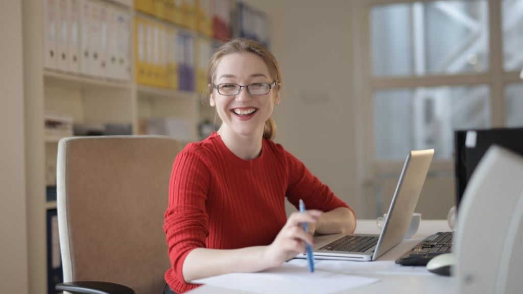 Young woman feeling happy at work