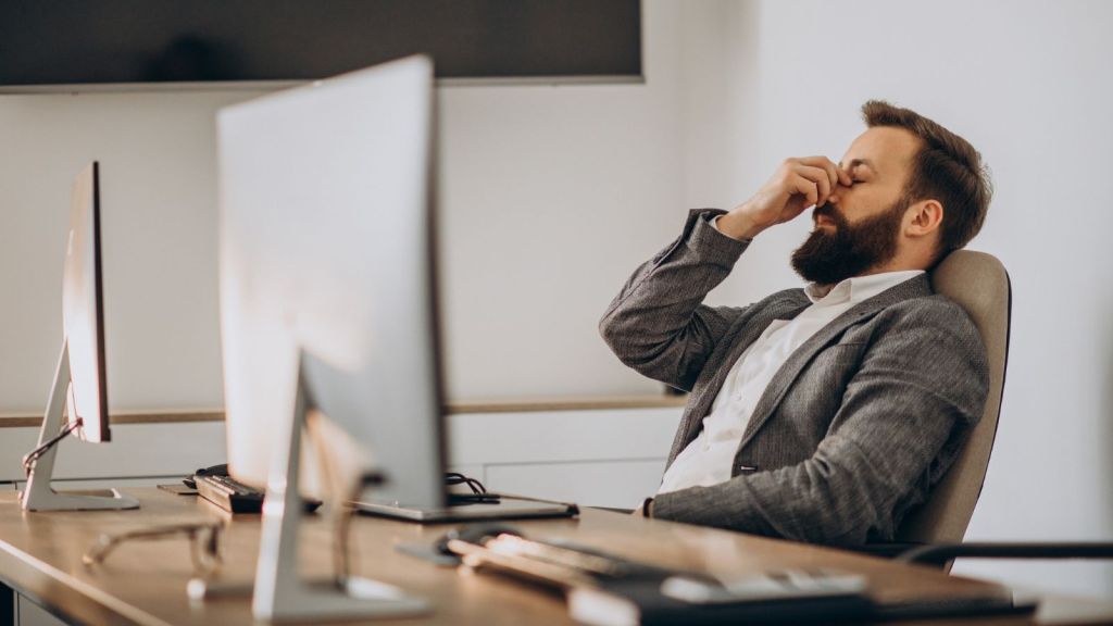 Man feeling tired in the office