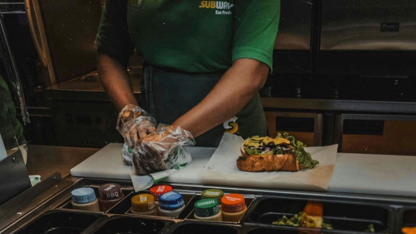 employee making sandwiches at Subway