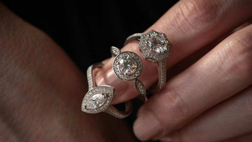 closeup of three wedding rings on woman's finger