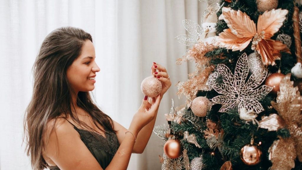 woman decorating Christmas tree