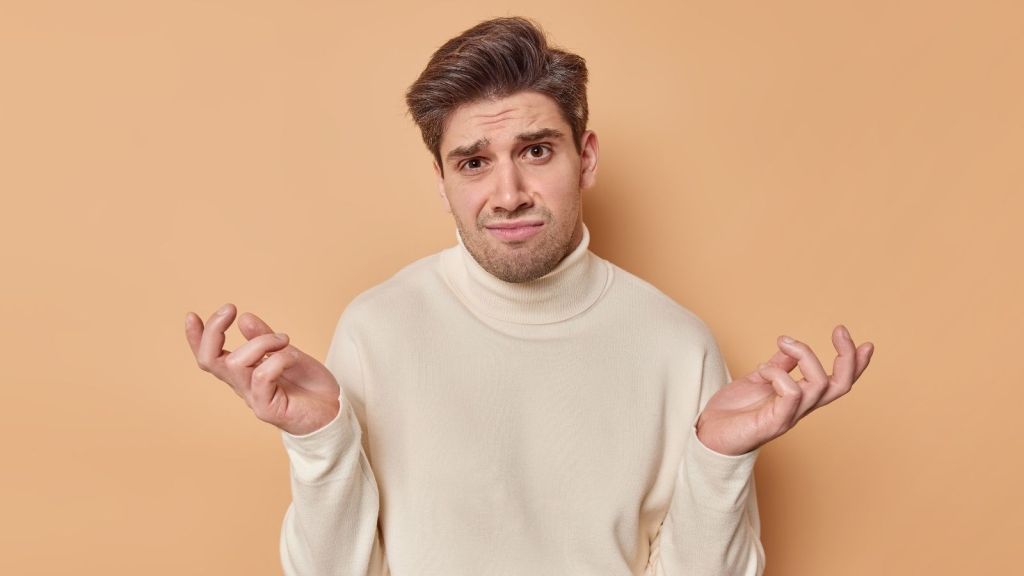 man shrugging and looking confused
