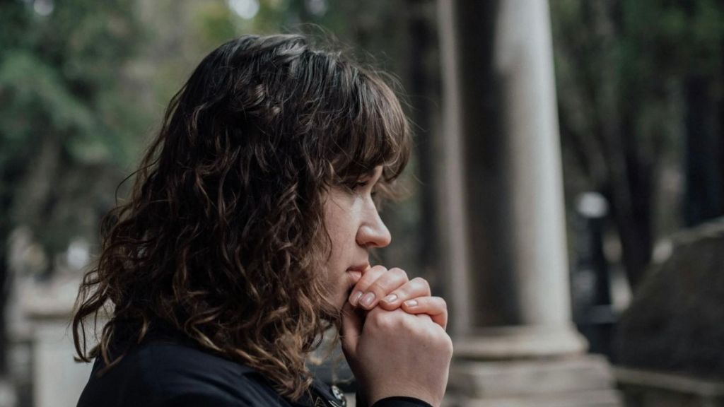 sad woman wearing black grieving