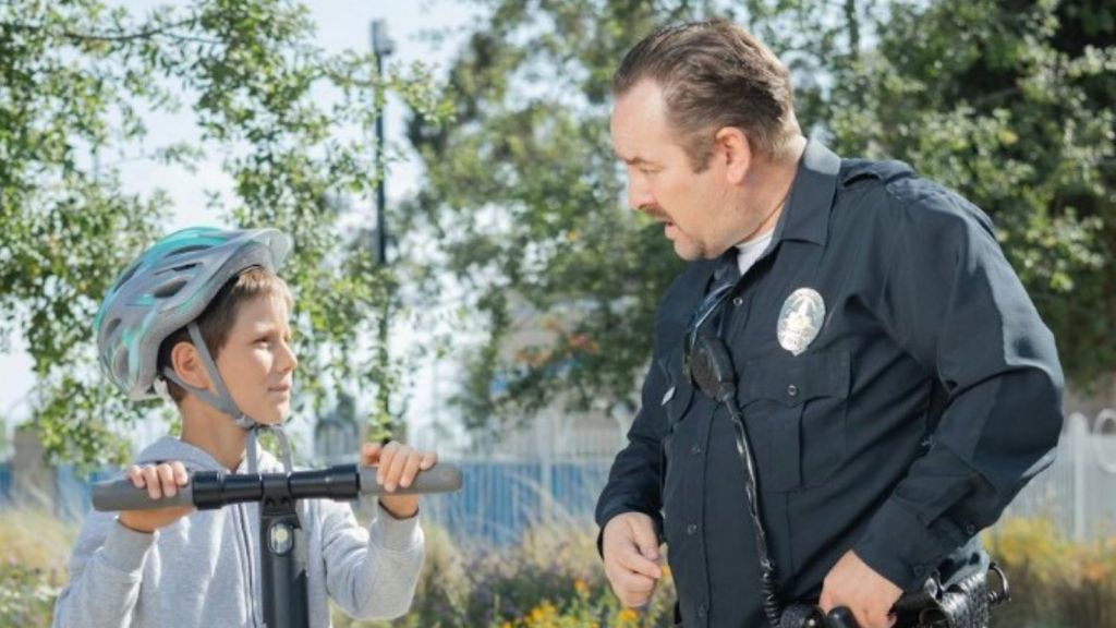 boy talking to police officer
