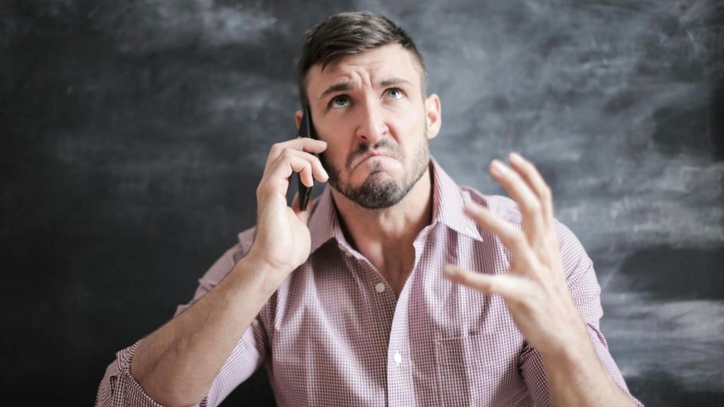 stressed out man talking on the phone