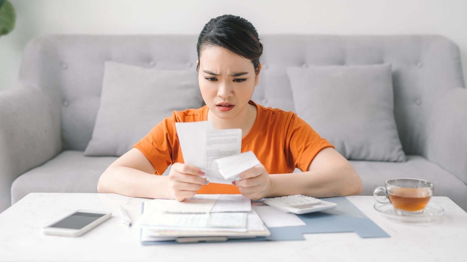 woman looking at receipts and bills