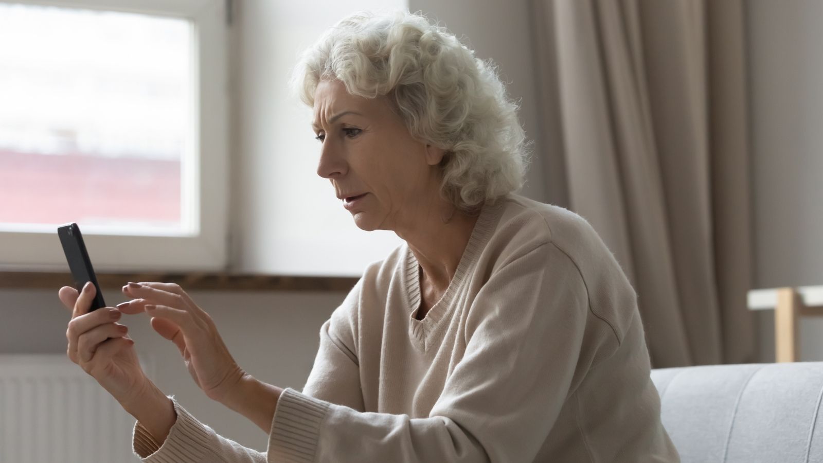 The Apartment Ambiguity: Why an Upstairs Neighbors Well Meaning Safety Text Backfired into Sudden Social Regret older woman looking at her phone