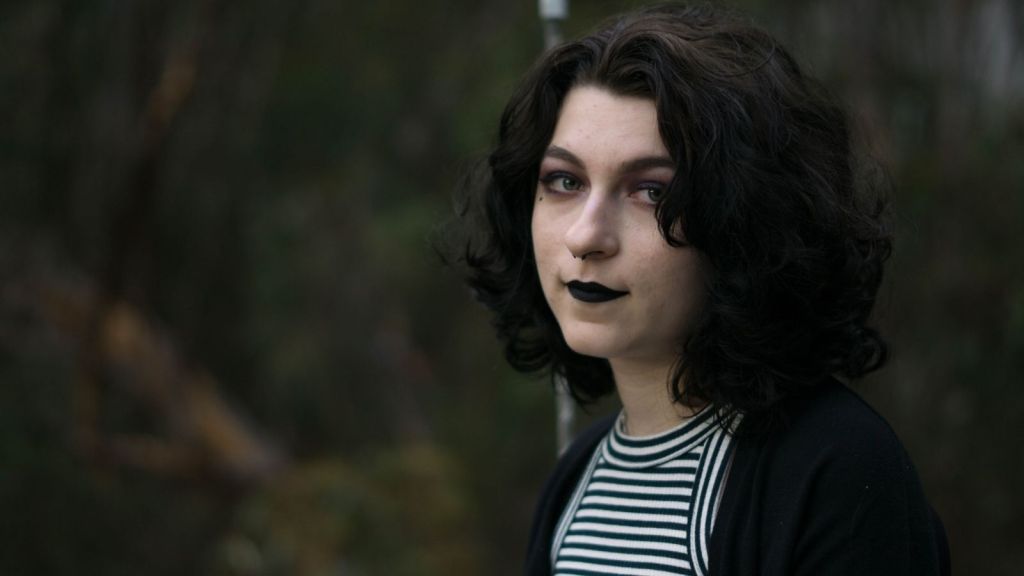 girl wearing black lipstick and clothing