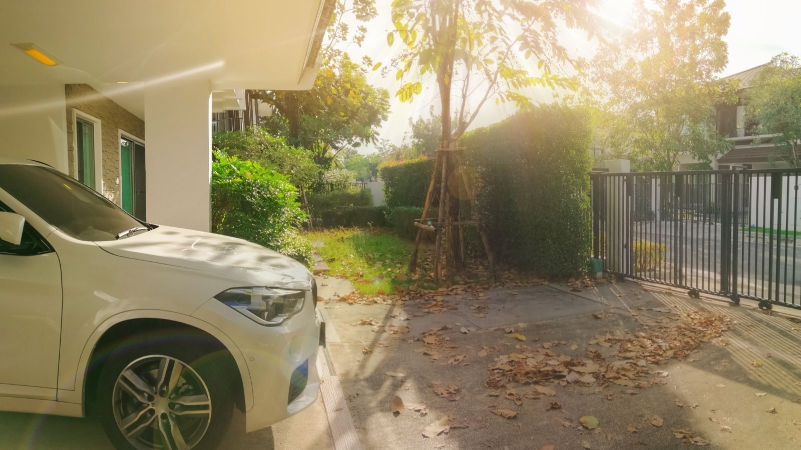 car parked outside house near gate