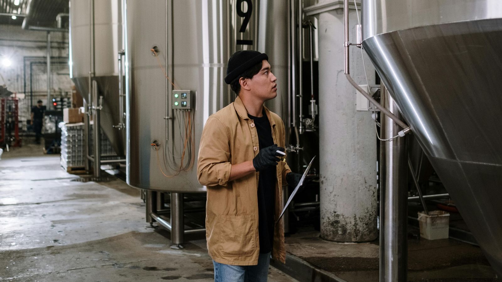 Man in brown jacket at a factory