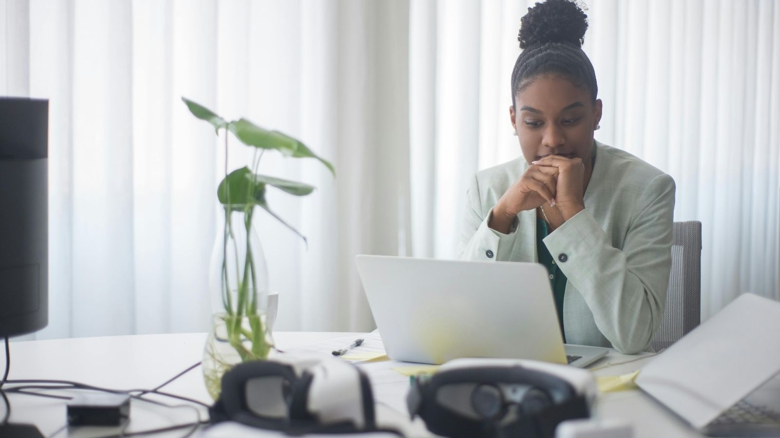 Woman looking at her laptop with a concerned facial expression