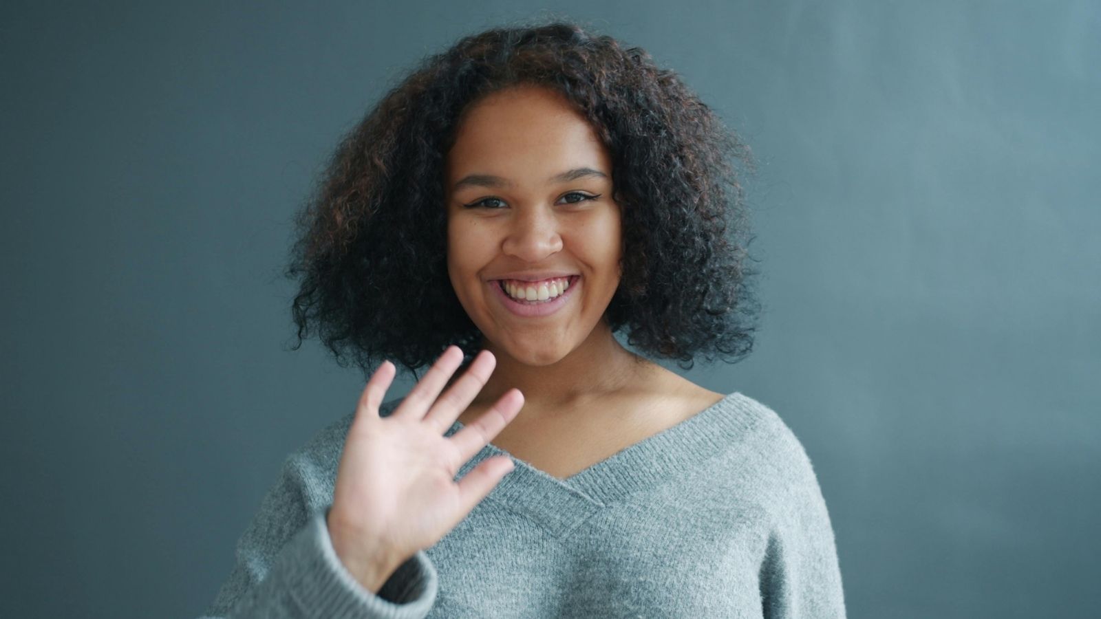 Woman smiling and waving