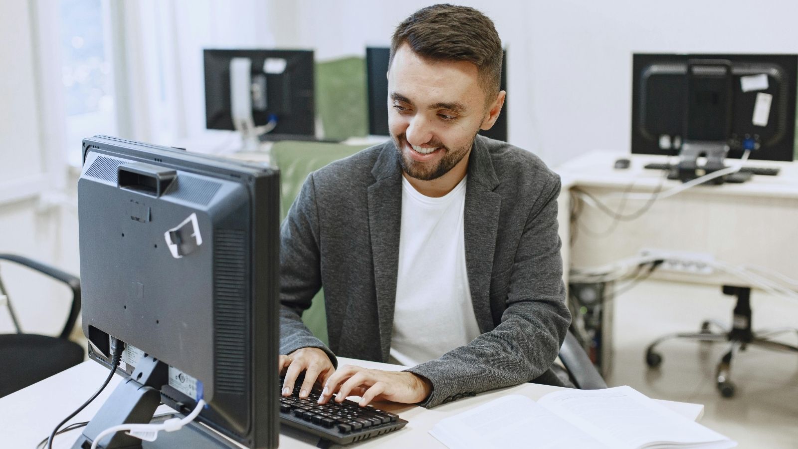 Computer Programmer Was Prevented From Making Requested Changes, so He Devised a Plan to Get the Team to Reconsider Man smiling and typing at work computer