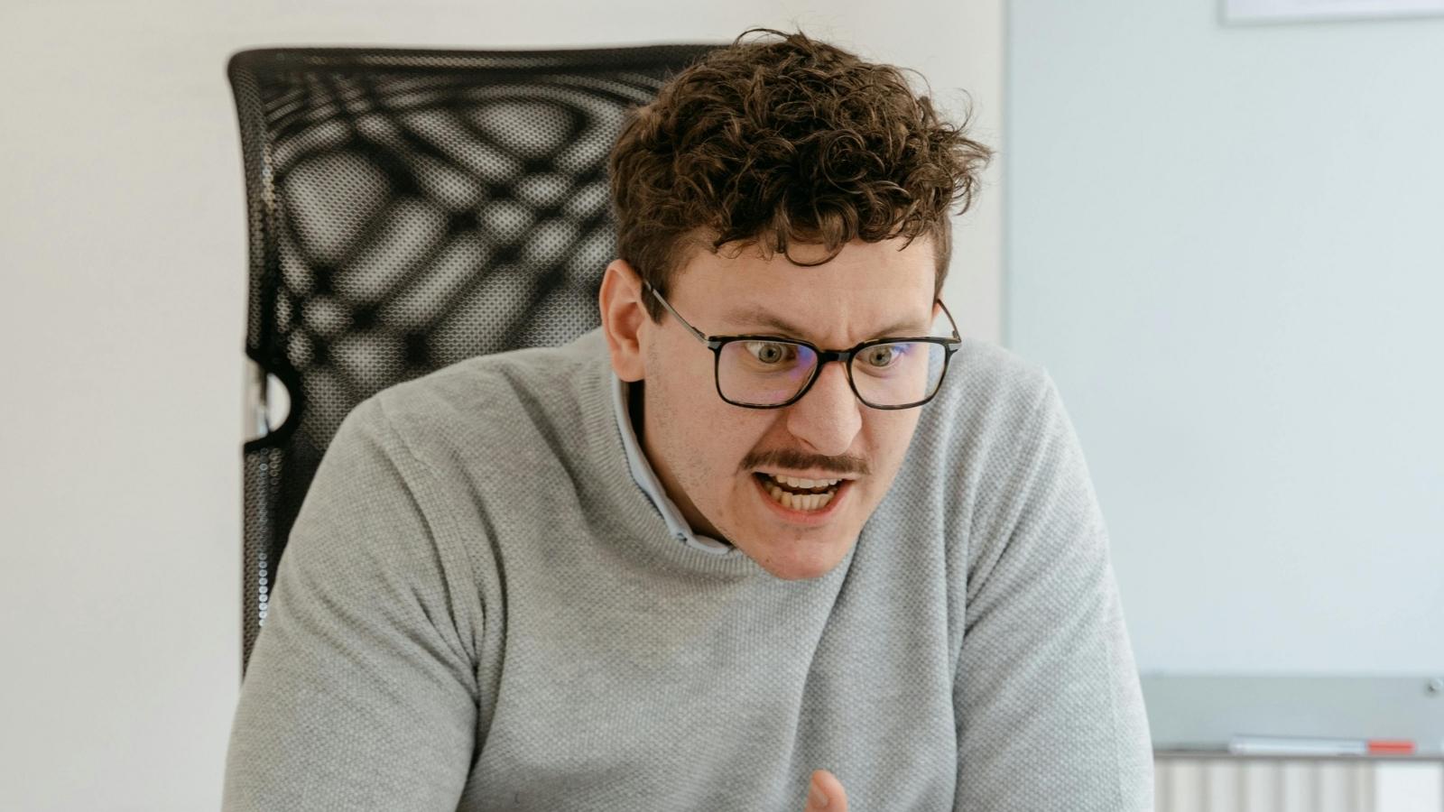 angry man sitting at his desk