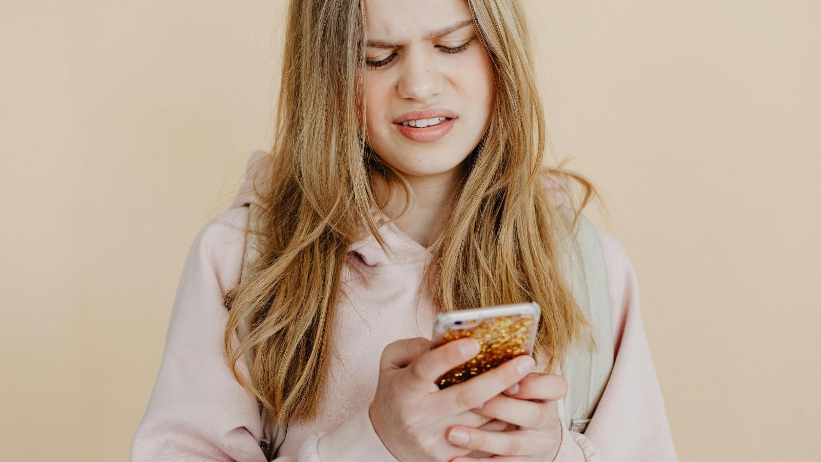 annoyed woman texting on her phone