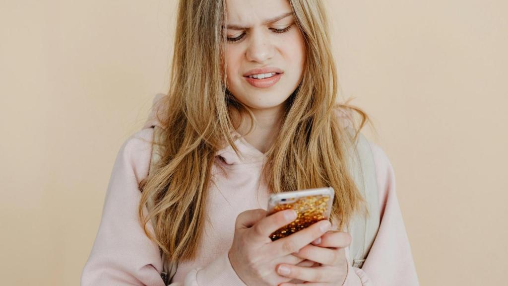 annoyed woman texting on her phone