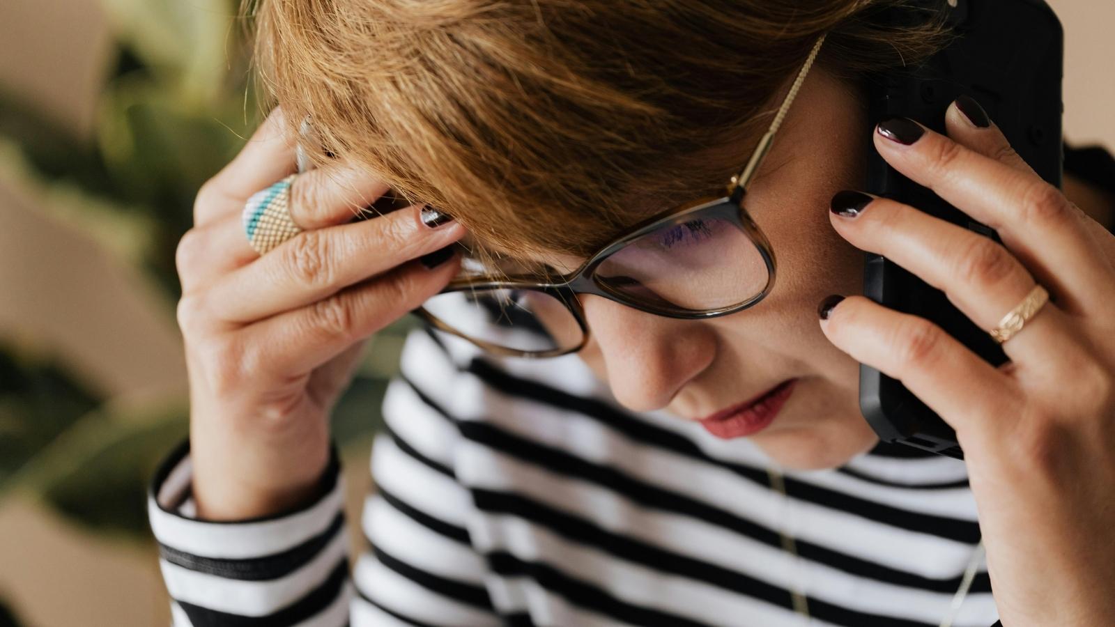 Aunt Continuously Left on Read by Her Niece Seriously Considers Halting All Family Gifts to Teach Her a Lesson in Manners anxious woman talking on phone in striped shirt
