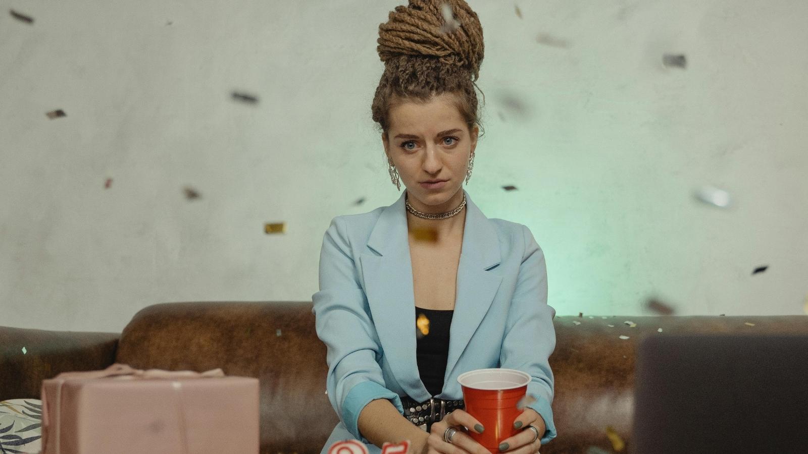 awkward woman sitting alone at a party