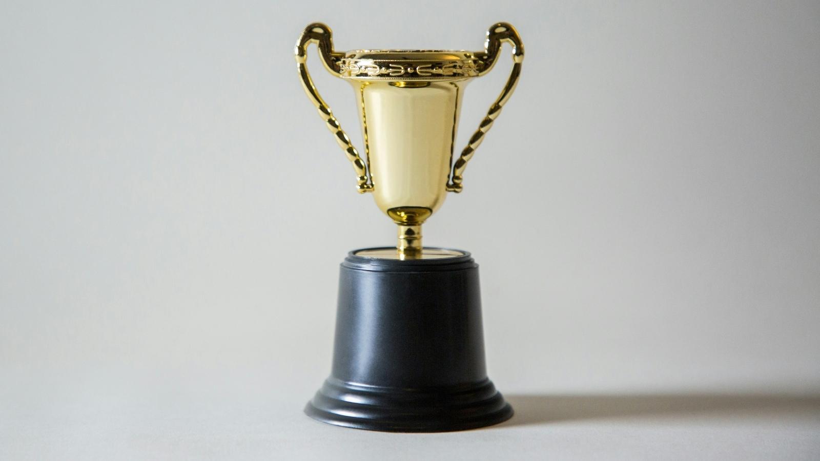 big gold trophy against gray background