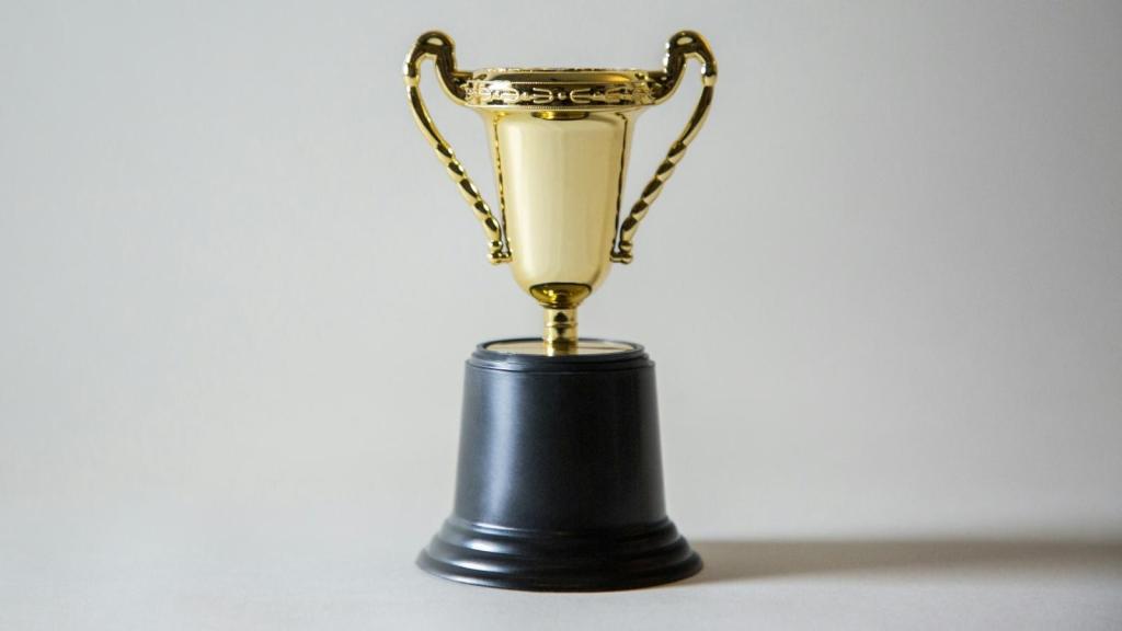big gold trophy against gray background