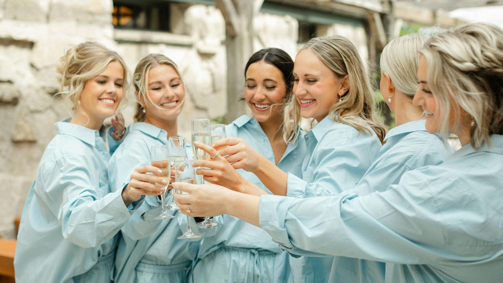 She Agreed to Wear a Dress and Makeup for Her Sibling’s Wedding, but Refused to Grow Out Her Hair—and Her Sister Turned the Family Against Her bridesmaids in light blue robes