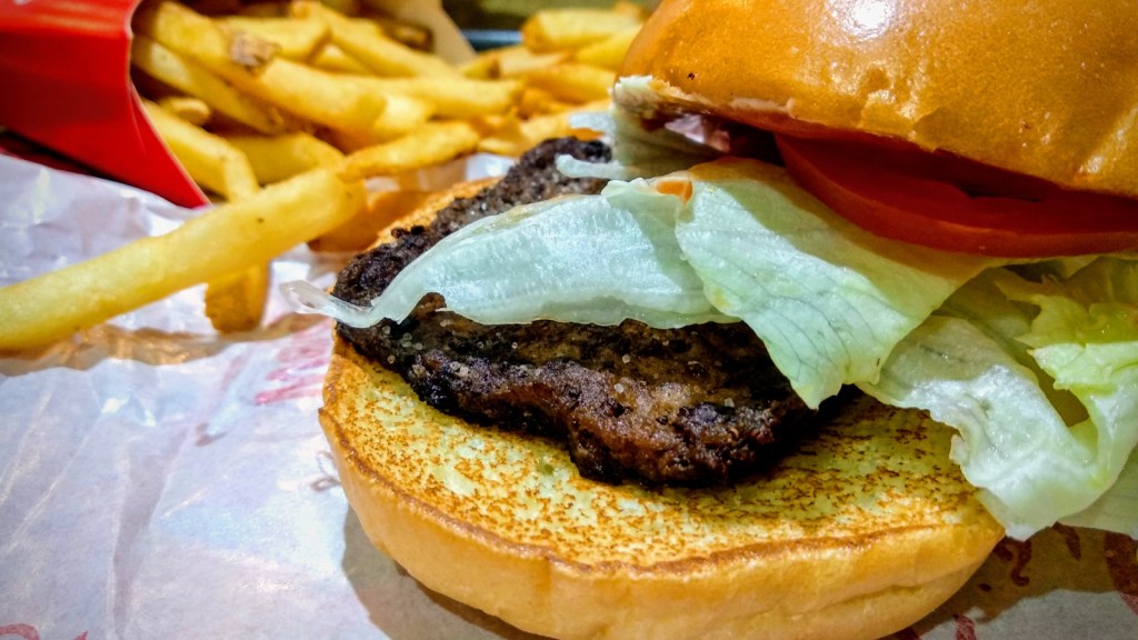 A burger and fries on a table