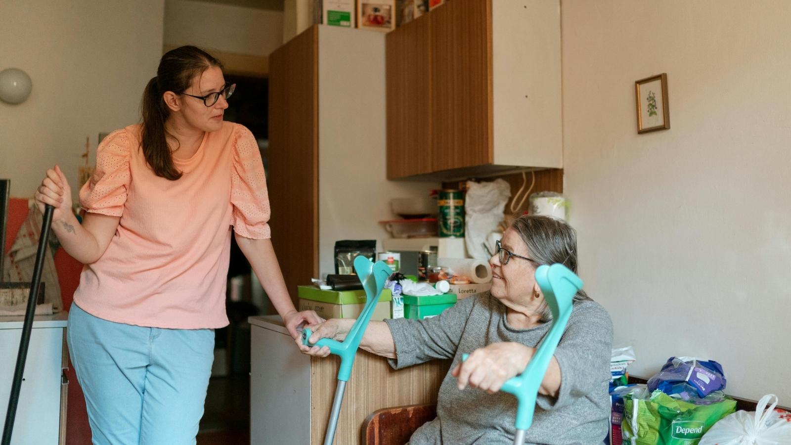 caregiver assisting her elderly mother