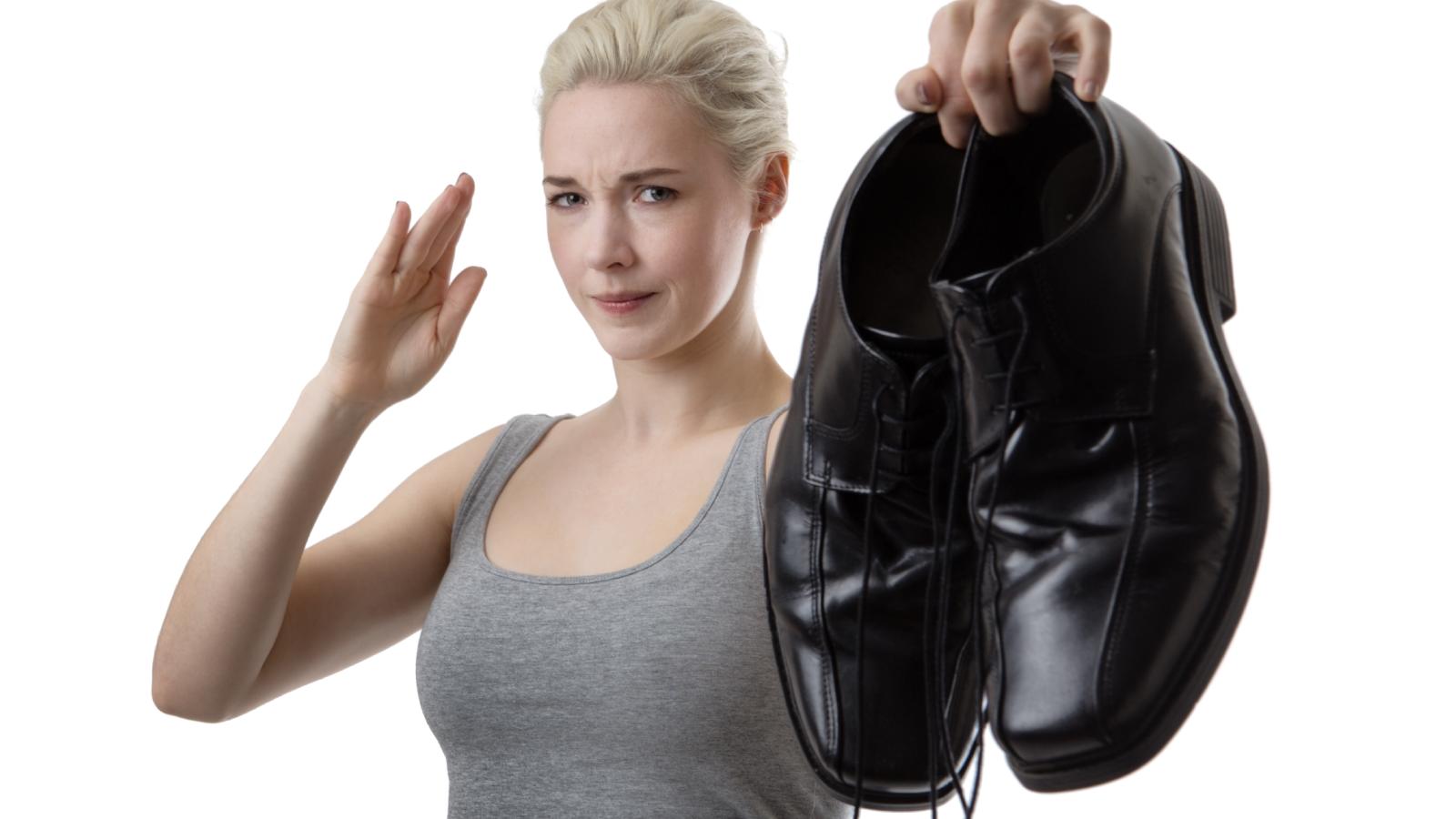 woman holding a pair of shoes