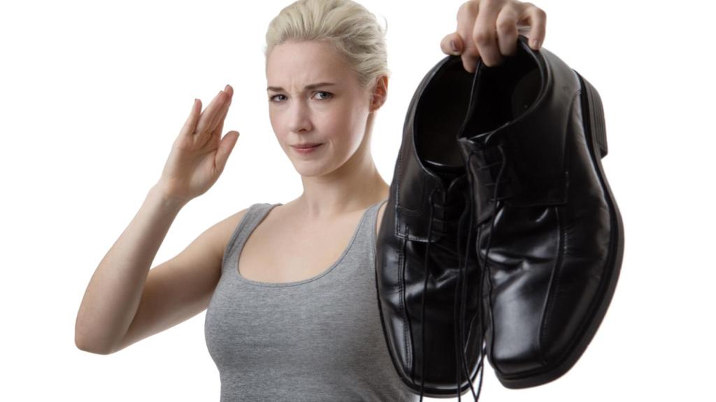 woman holding a pair of shoes