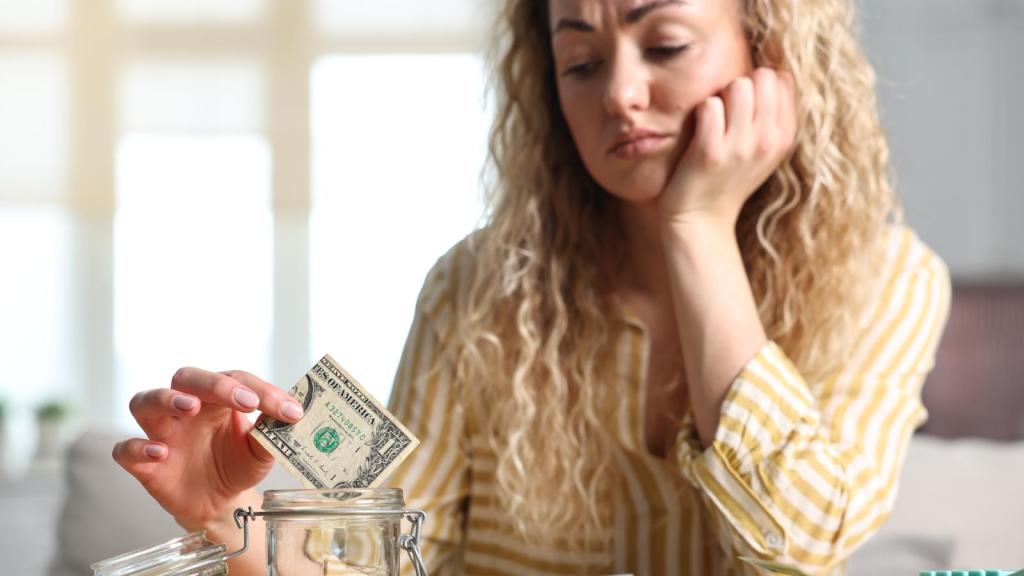 woman putting money in a jar