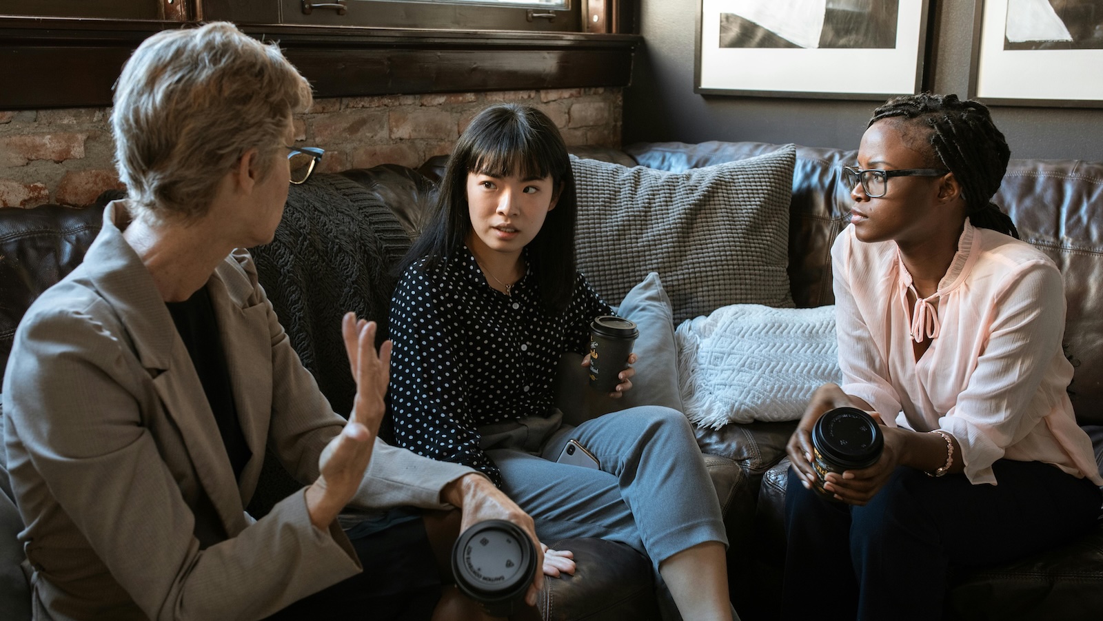 friends chatting on the couch looking concerned