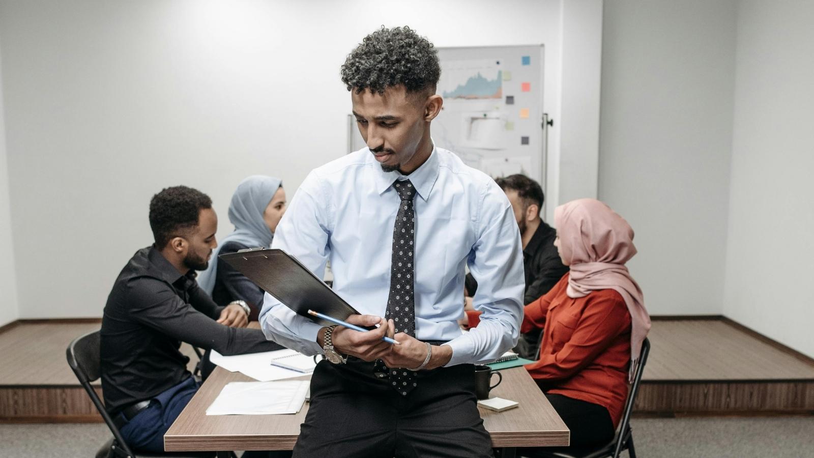 Employee’s Hilarious Agenda Malicious Compliance Forces Boss to Rewrite Company Policy corporate employee sitting in conference room