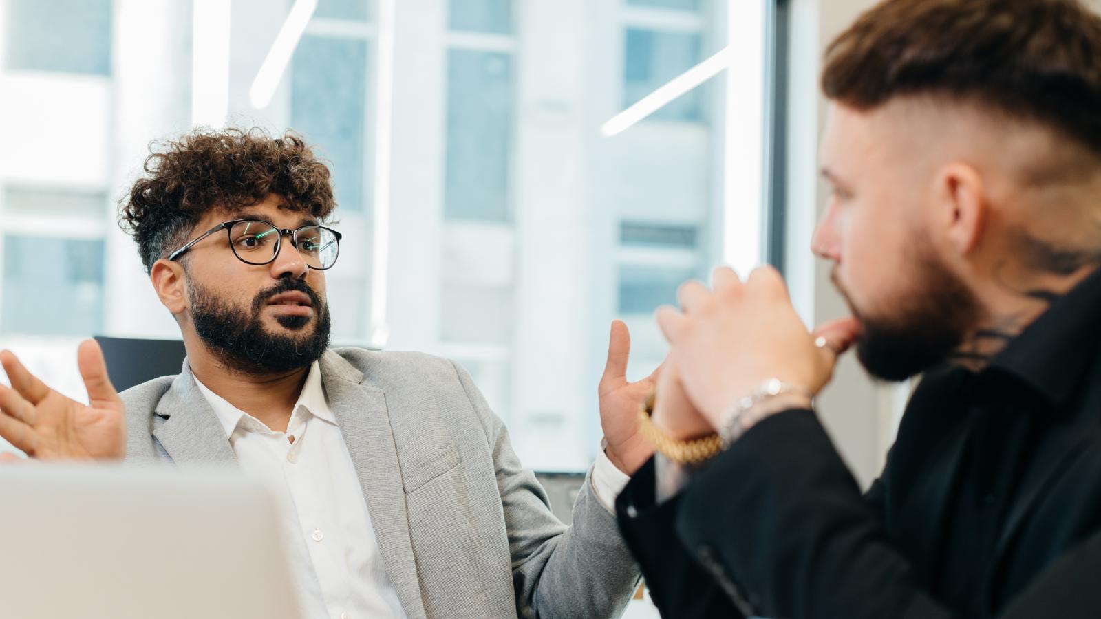 A Man Complained to the Boss About How His Female Co Worker Spends Her Own Money, So HR had to Step In two men in an office