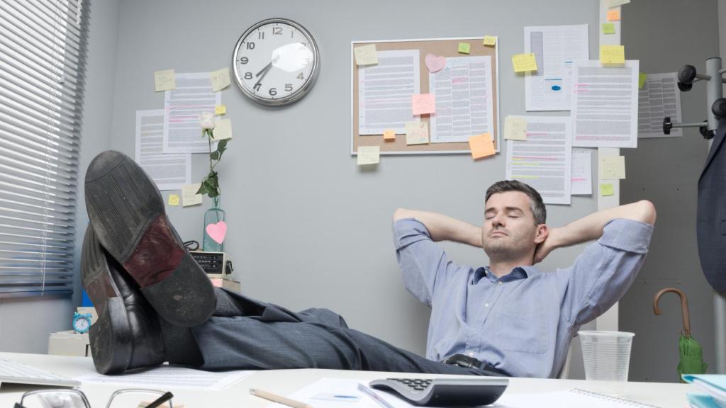 man with feet up on desk