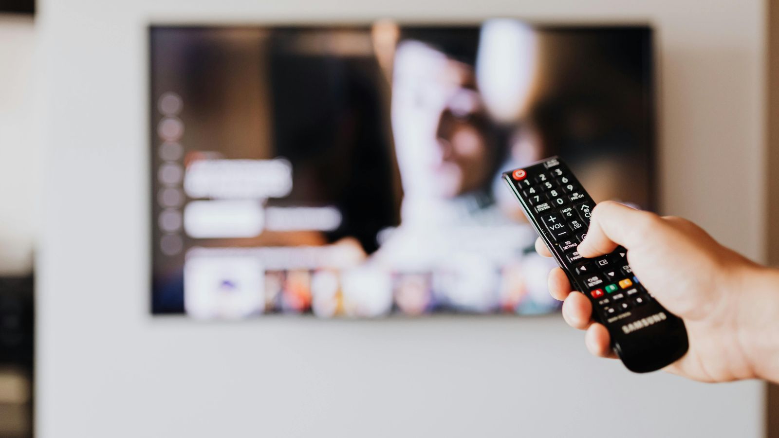 Hand holding a smart TV remote