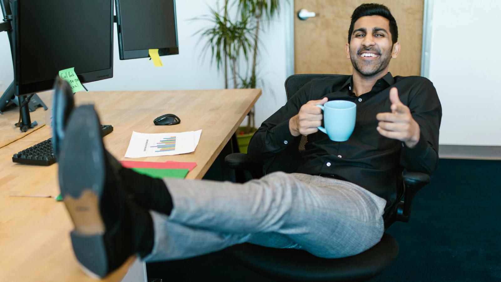 Employee Stops Going Above and Beyond After Missed Promotions, Then Unexpectedly Gets a Raise man with feet on desk