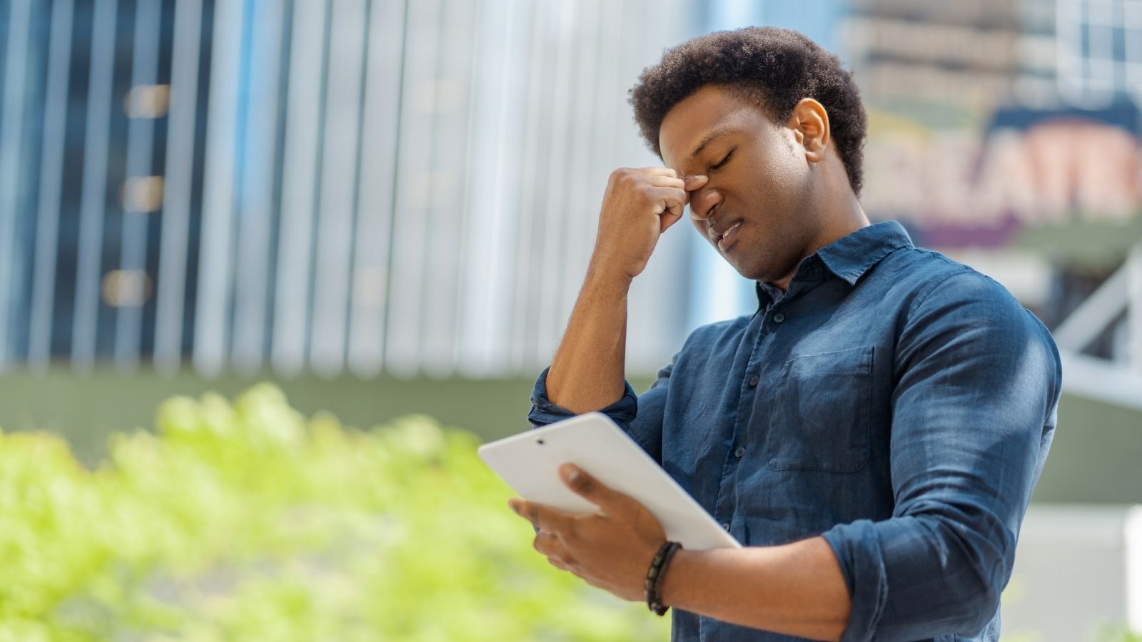 frustrated man looking at iPad
