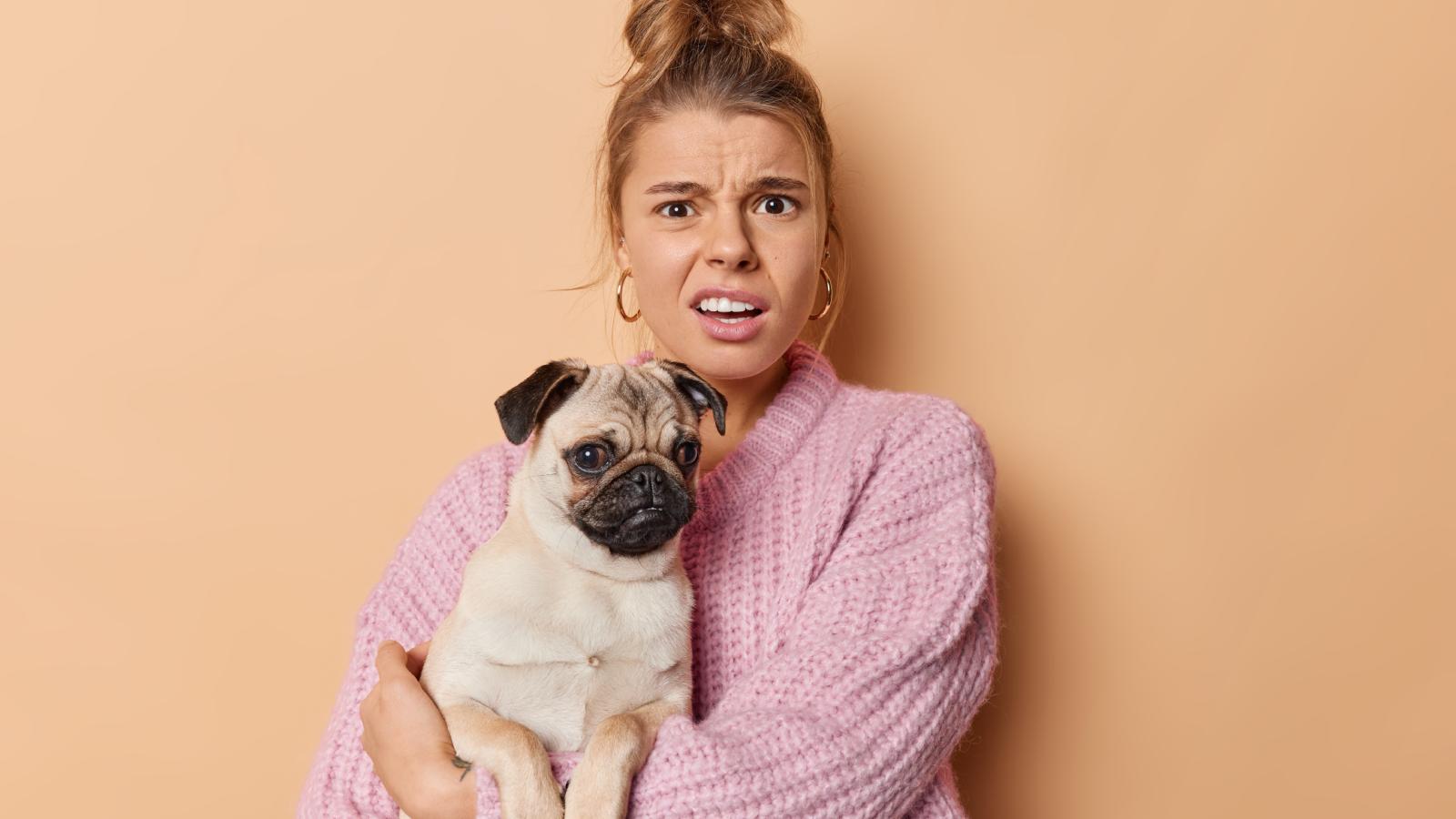 woman holding a dog