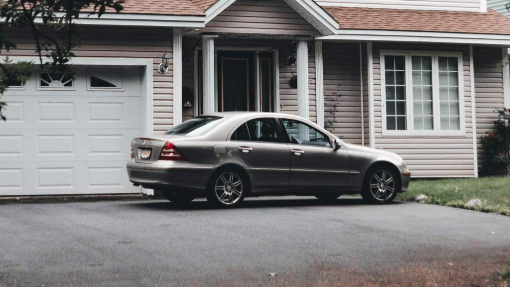 grey car parked in front of house