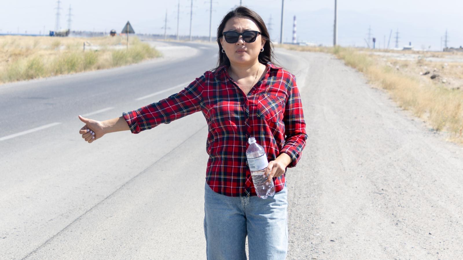 young woman on side of the road